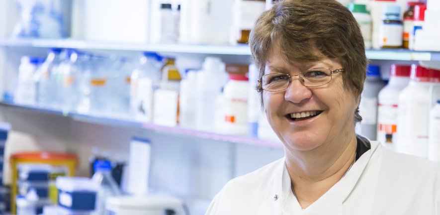 Jane Clarke in the lab smiling at camera