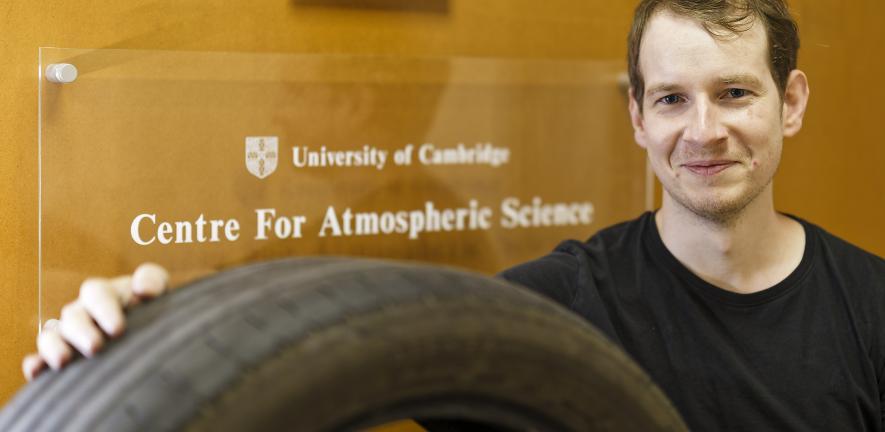Siriel with a tyre in front of the 'University of Cambridge Centre For Atmospheric Science' sign. 