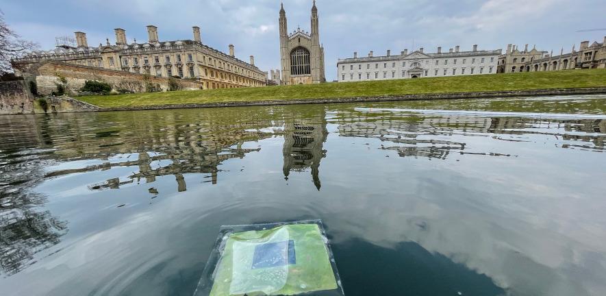 An artificial leaf floating on the River Cam in front of King's College Chapel