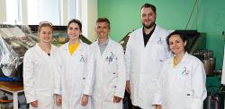 The Lambda Energy team stands in a lab