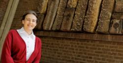 Head and shoulders image of Clare Grey in front of red brick building