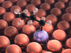 Inert metal particles (red) with a single reactive metal particle (purple) catalyst reacting with a propane molecule (black).