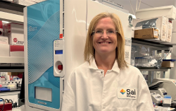 A woman in a white lab coat in a laboratory.