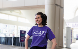 A woman in a purple tshirt in light spacious hall