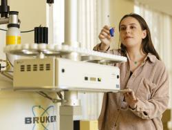 A woman in a laboratory in front of a machine