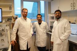 Three men in lab coats in a laboratory