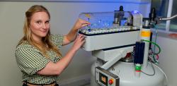 Leah Webster operates an NMR machine.