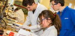 Students wearing lab coats in the teaching lab