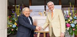 Dr Yusuf Hamied and Stephen J. Toope shaking hands in front of the brass plaque