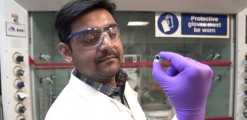 Dr Motiar Rahaman holds the tiny, square artificial leaf