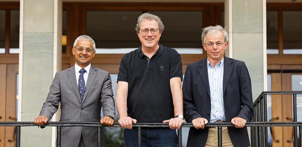 Image on a balcony showing Prof. Shankar Balasubramanian, Prof. Pascal Mayer, and Prof. David Klenerman. 