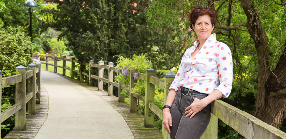 Melinda Duer outdoor shot leaning on fence post