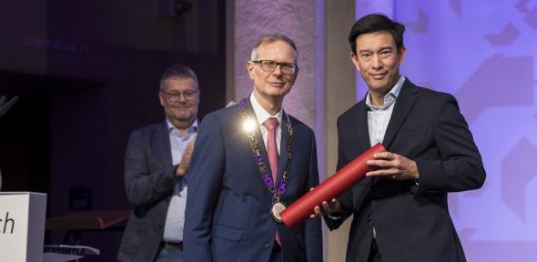Chin being presented his honorary diploma by someone at ETH