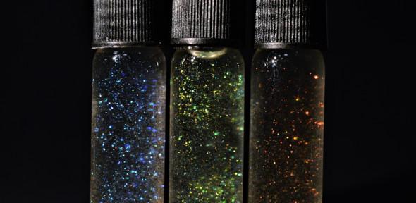Three vials of glitter prepared from cellulose nanocrystals.