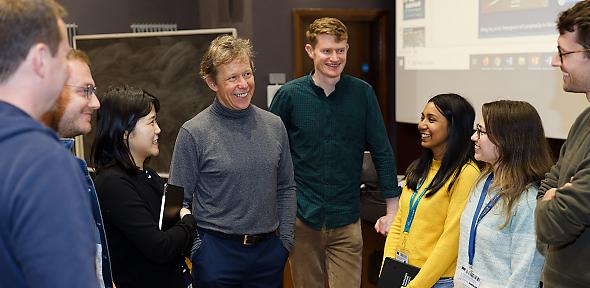 Professor Kotov smiling with students