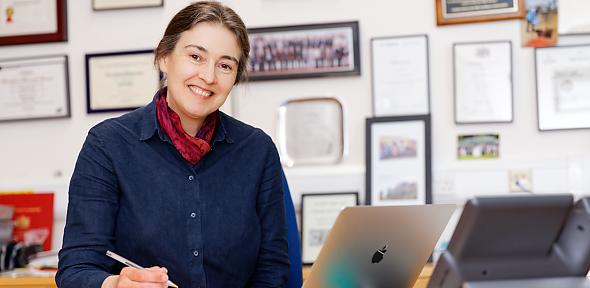 Head and shoulders image of Clare Grey at desk