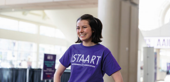 A woman in a purple tshirt in light spacious hall