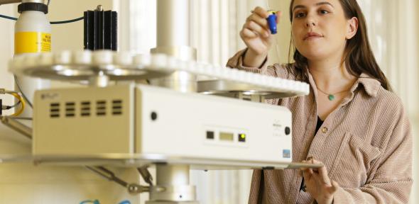 A woman in a laboratory in front of a machine