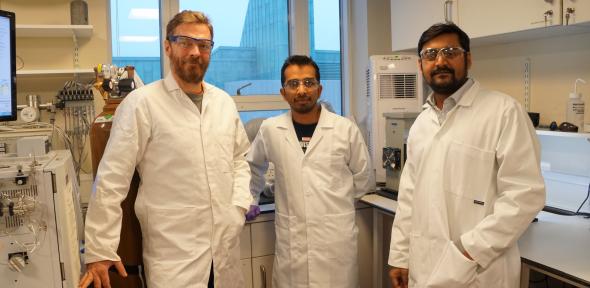 Three men in lab coats in a laboratory