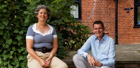 Two people sit on garden steps