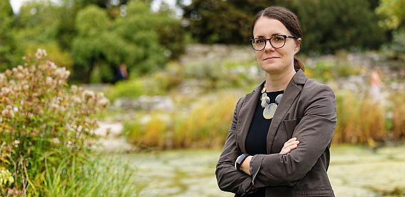 Ruth Webster in botanic gardens smiling at camera
