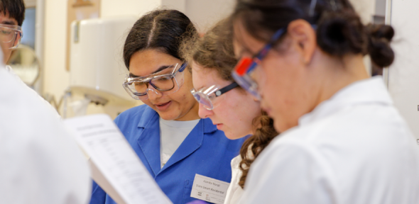 Three students look at their worksheets.