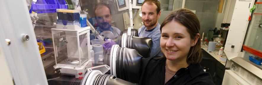 Megan and Darren using fume cupboard and smiling at camera
