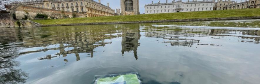 An artificial leaf floating on the River Cam in front of King's College Chapel