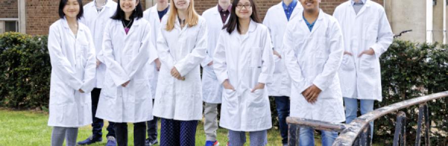 Members of the ChemSoc committee standing in a group wearing lab coats