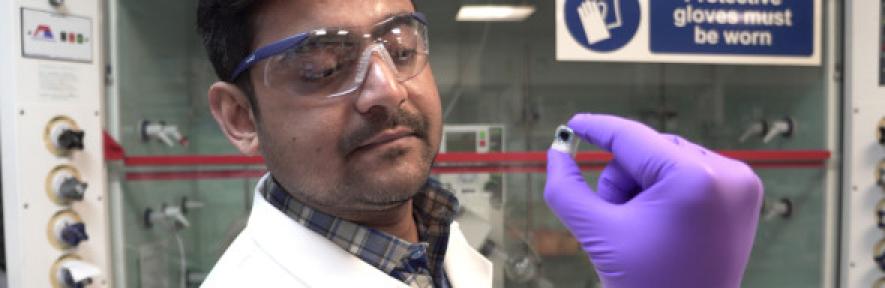 Dr Motiar Rahaman holds the tiny, square artificial leaf