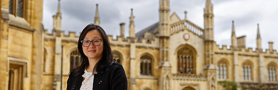 Jenny Zhang with Corpus Christi college in background, smiling at camera
