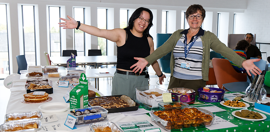 Emma Solaas and Kathleen Pickett being happy looking at the cakes