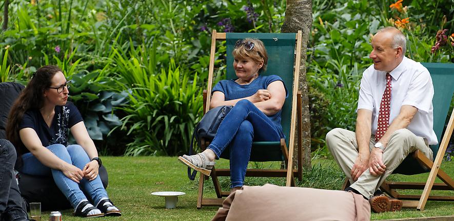 James Keeler and two others relaxing on chairs at garden party