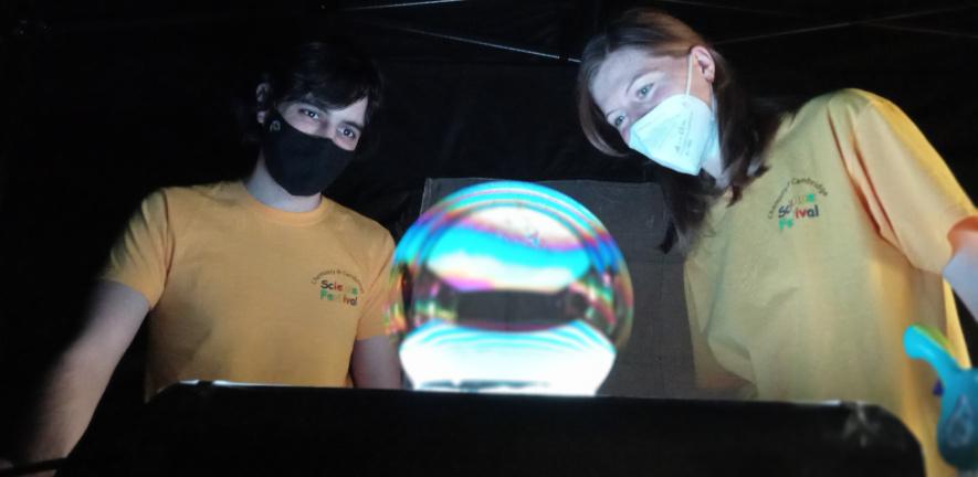Two researchers in Covid masks watching experiment