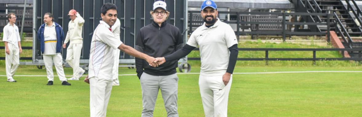 Dr Amit Dahiya shakes hands with Molecular Biology team captain while referee looks on