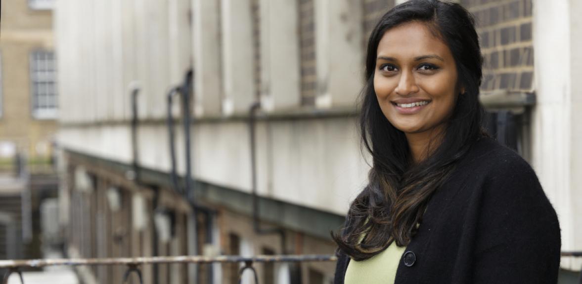 Aruna standing on stairs outside Chemistry smiling at camera