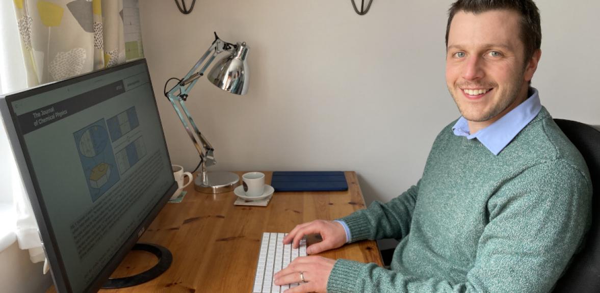 Stephen Cox sitting at his desk