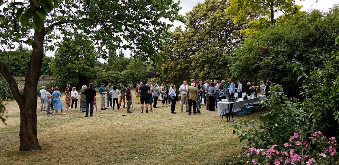 Long view of Peterhouse Deerpark with people chatting