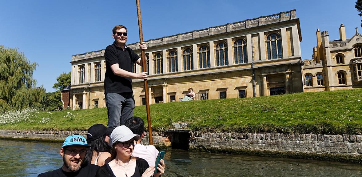 David Morgan punting a few smiling staff members on the Cam