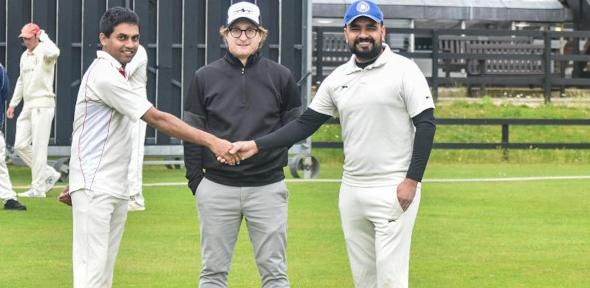 Dr Amit Dahiya shakes hands with Molecular Biology team captain while referee looks on