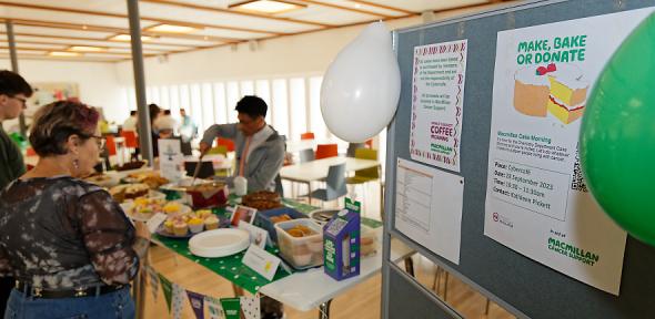 Chung Tu serving cakes at the Macmillan cake morning