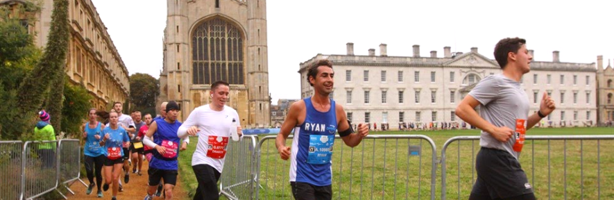 People running with King's College Chapel in the background